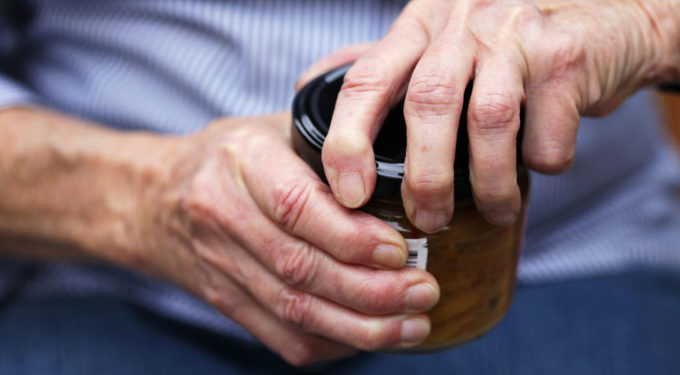 Elderly lady opening a jar