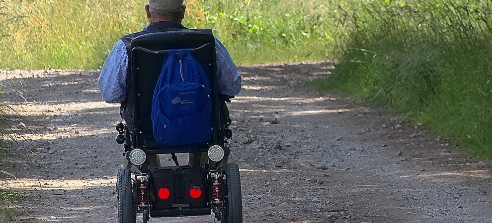 elderly man using an electric wheelchair